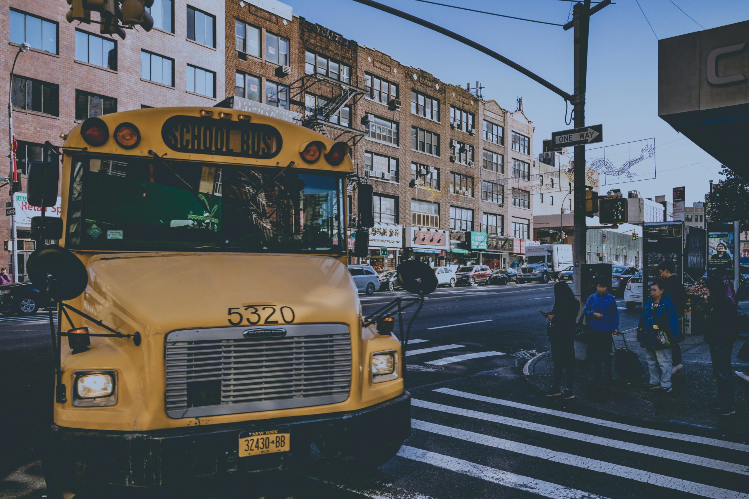 Yellow school bus driving down the street, highlighting school bus transportation in action.