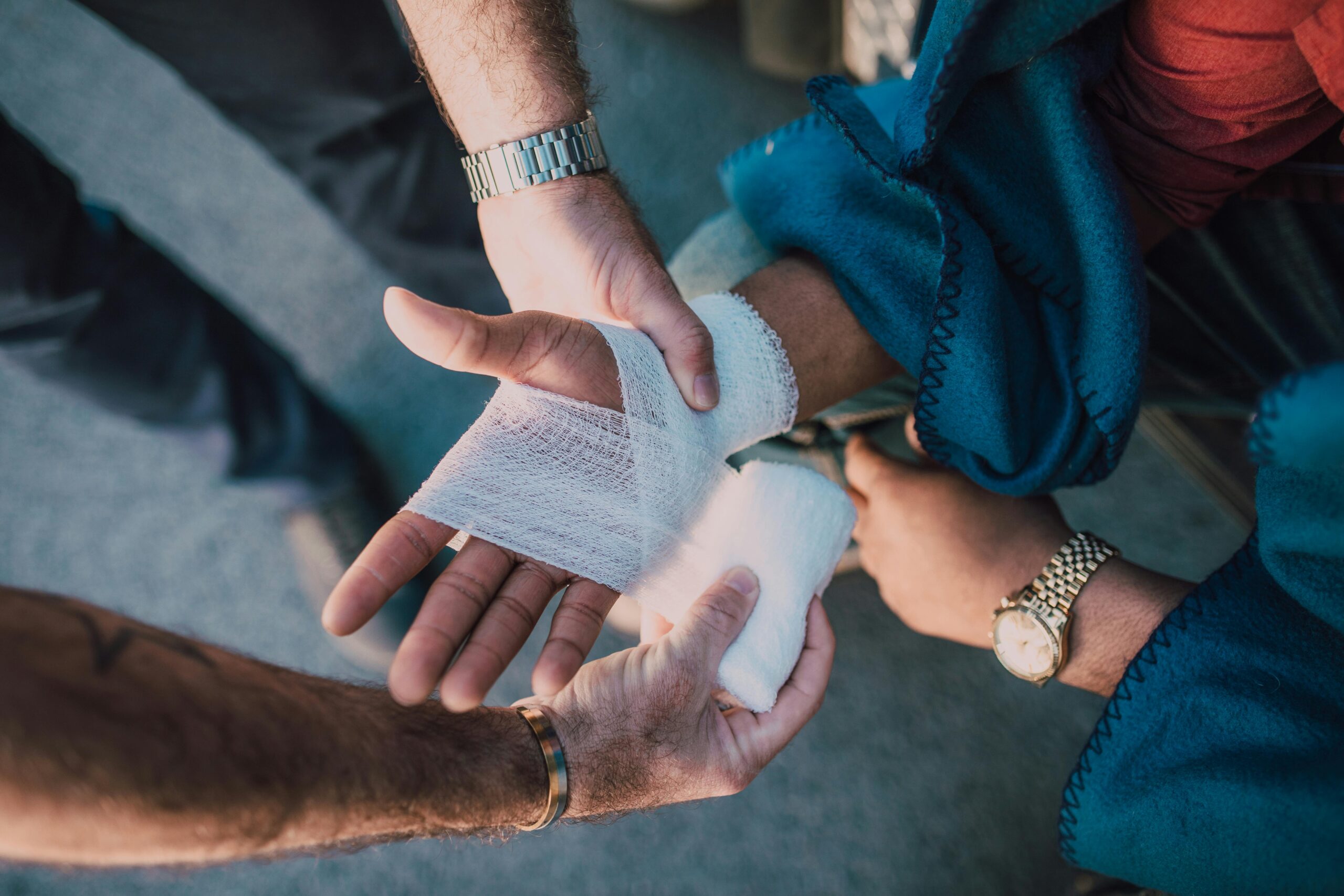 Close-up of a bandaged hand, representing the impact of disfiguring injuries on self-esteem.