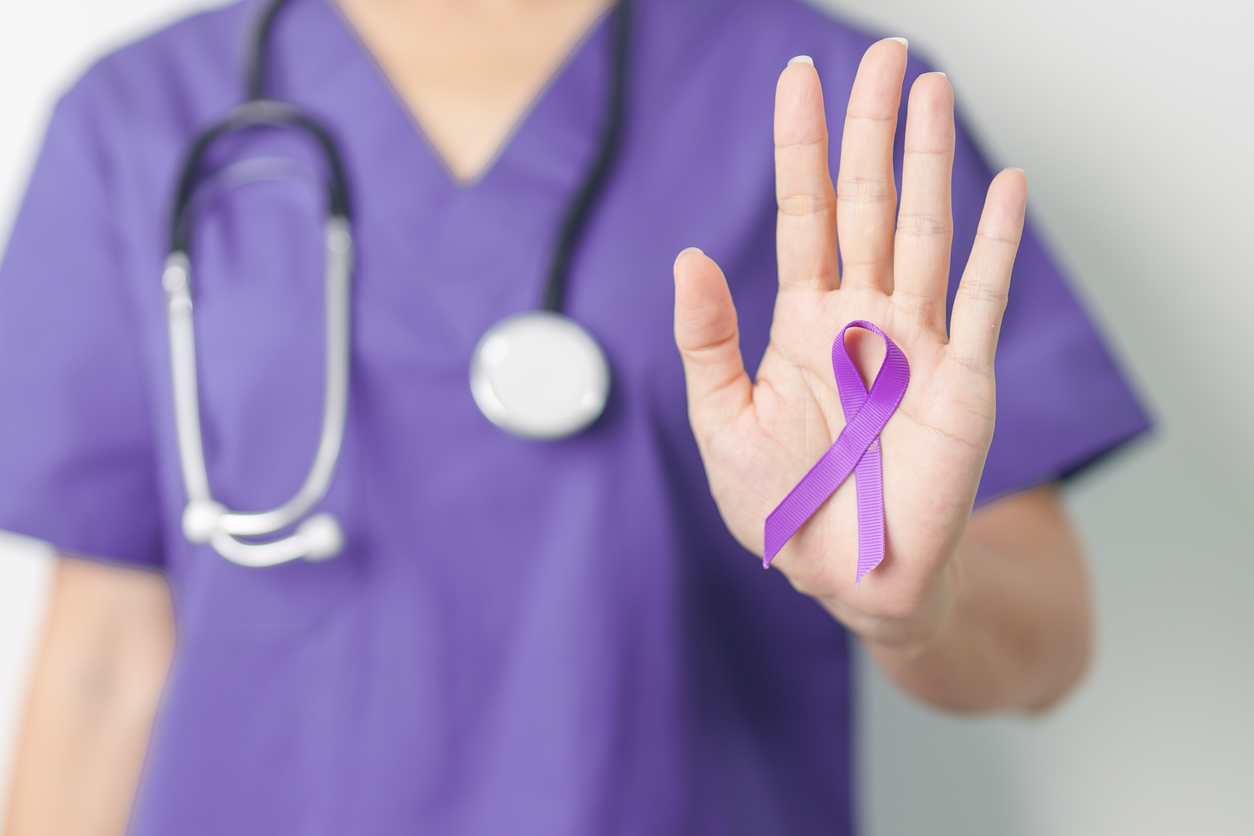 Doctor holding purple Ribbon for Violence, Pancreatic, Esophageal, Testicular cancer, Alzheimer, epilepsy, lupus, Sarcoidosis and Fibromyalgia. Awareness month and World cancer day concept