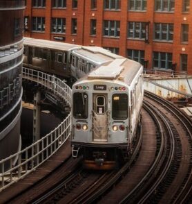 El train traveling on elevated tracks in an urban Chicago setting